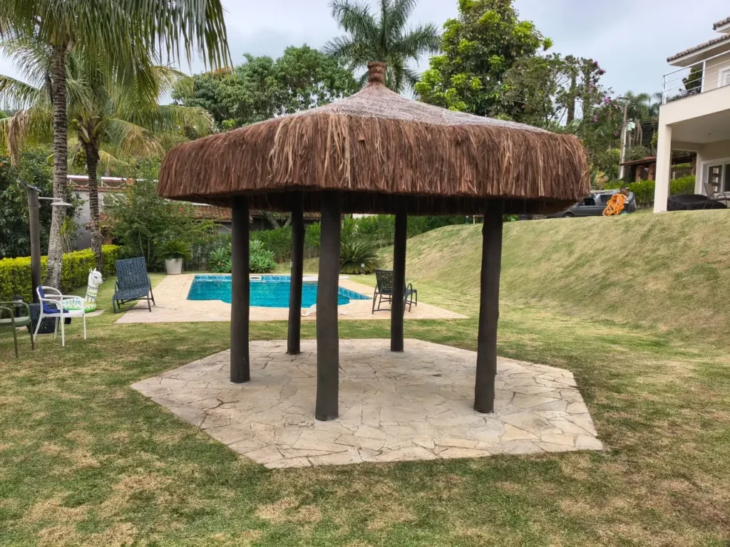 Quiosque de piaçava em terreno residencial